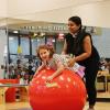 Esty is on a huge red ball, whie Krupa supports them