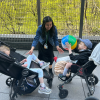 Two MSA students in adaptive strollers are outside playing catch with a beach ball, supported by a staff person in the middle