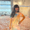 MSA student poses for camera, they are covered in colorful powder