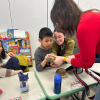 MSA student touching a tortoise that a staff person is holding for them