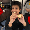 MSA student smiles while holding some food they look like they're about to eat