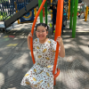 MSA student sits on a swing in a playground