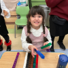 MSA student smiles as they hold counting pieces