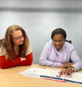 Two women reviewing an Easy Read Document from ReadAble