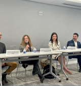 4 panelists sit at a table