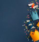 Birthday party hats and streamers on a dark blue background