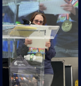 Janice stands at the podium at the Central Park Challenge and reads her speech