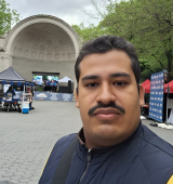 Orlando stands in front of the Bandshell in Central Park