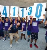 Group of people hold up numbers with Kevin Carey at the forefront