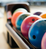 close up of bowling balls at a bowling alley