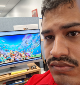 Orlando poses with super mario on the screen behind him