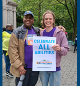 Kenneth (left) and Timothy (right) pose together with a "Celebrate All Abilities" poster at CPC