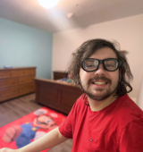 Tyler smiles for the photo, you can see his new bedroom behind him.