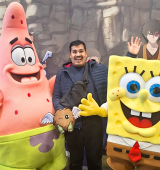Orlando stands between two people costumed as Spongebob Squarepants and Patrick
