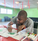 Justin at the respite center in Kingston, he's focused on coloring in. 