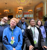 Group of 5 STAR students with staff stand outside a cafe for a group photo
