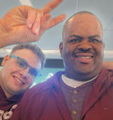 kenneth and a friend stand together for a selfie