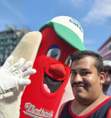 Orlando (right) poses with someone in a nathan's hotdog costume