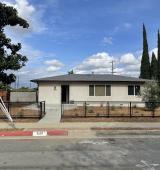 house with trees on either side and blue sky. how is located in California