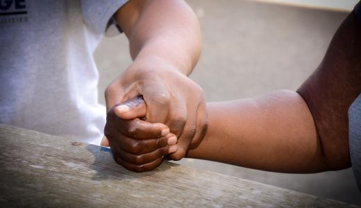 close up of two people holding hands