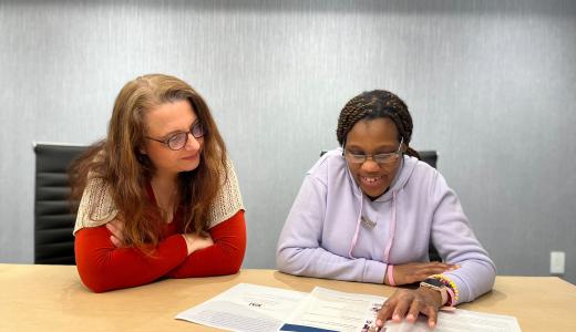 Two women reviewing an Easy Read Document from ReadAble