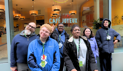 Group of 5 STAR students with staff stand outside a cafe for a group photo
