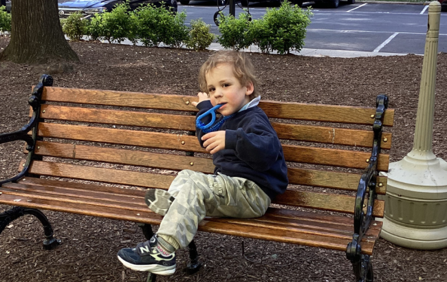 MSA student sits on a park bench
