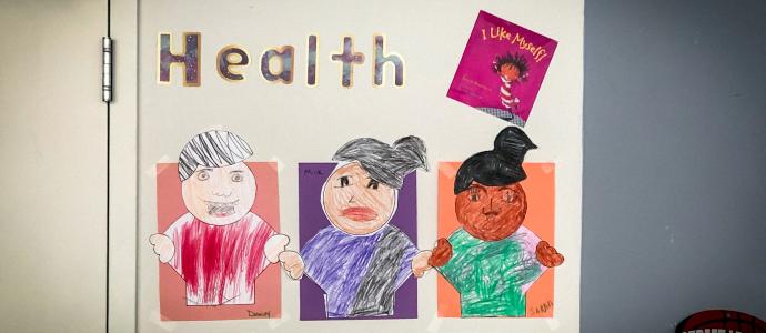 Hand made poster with the word "health" portrays 3 people