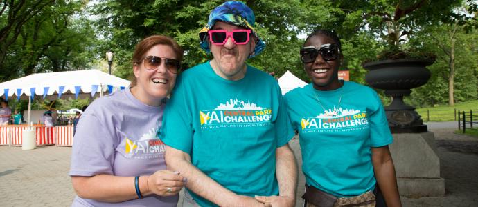 3 people stand side-by-side in Central Park NYC, one in the middle has sassy pink sunglasses on