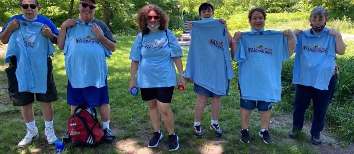 Group of 6 people from NIPD/NJ stand outside wearing matching blue shirts