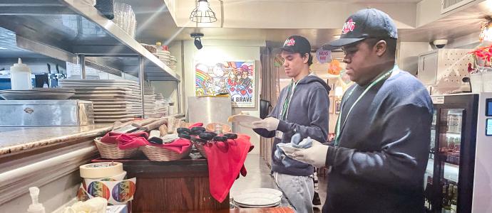 Two MSA student interns working in the kitchen of a restaurant