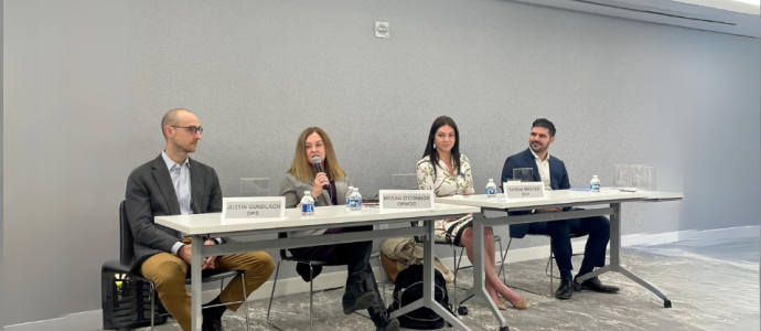 4 panelists sit at a table