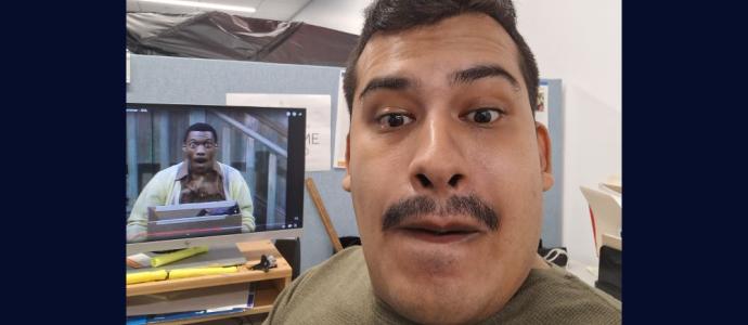 Orlando copies the facial expression of Eddie Murphy on SNL (on monitor behind him)