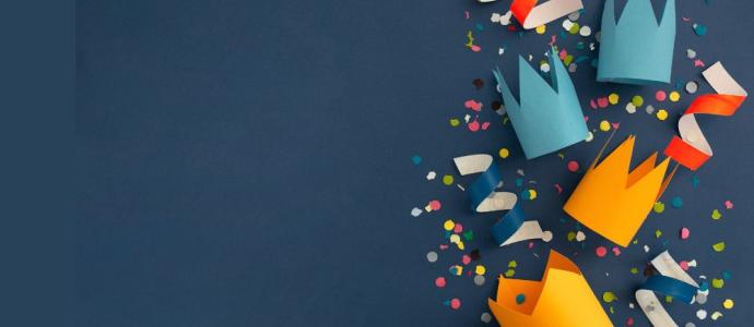 Birthday party hats and streamers on a dark blue background