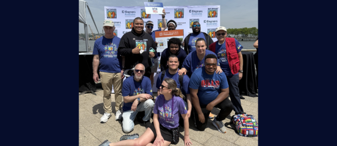 Group of people at the Best Buddies walk post on the pier with Ismael on the right hand side of the picture