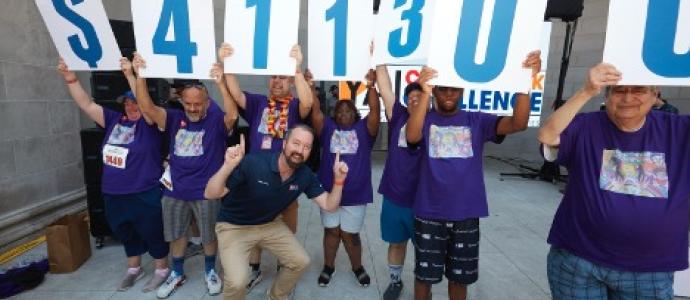 Group of people hold up numbers with Kevin Carey at the forefront