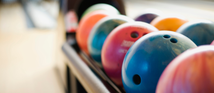 close up of bowling balls at a bowling alley