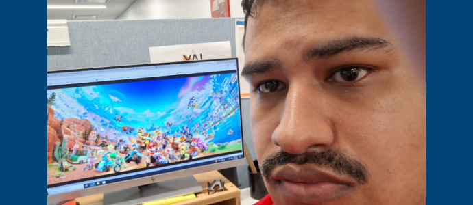 Orlando poses with super mario on the screen behind him