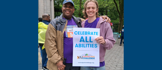 Kenneth (left) and Timothy (right) pose together with a "Celebrate All Abilities" poster at CPC