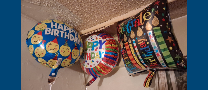 3 balloons float at the ceiling for Kenneth's birthday