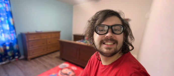 Tyler smiles for the photo, you can see his new bedroom behind him.