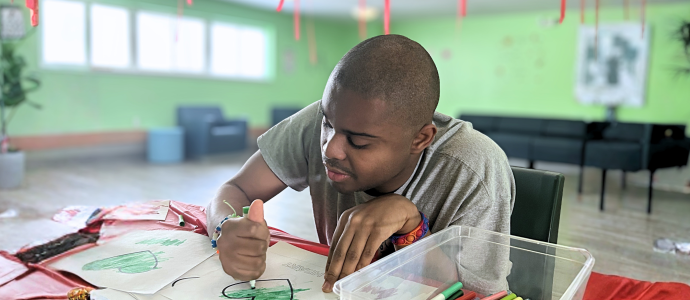 Justin at the respite center in Kingston, he's focused on coloring in. 