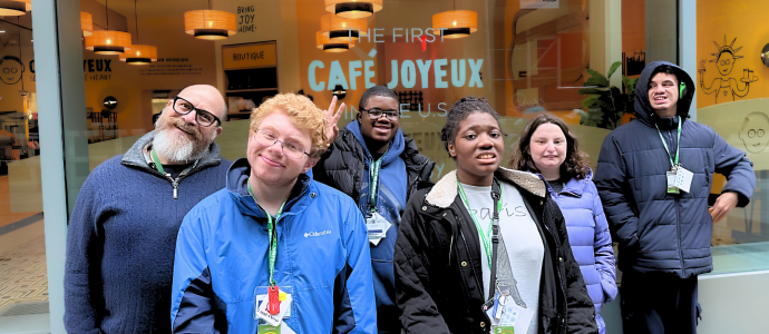 Group of 5 STAR students with staff stand outside a cafe for a group photo