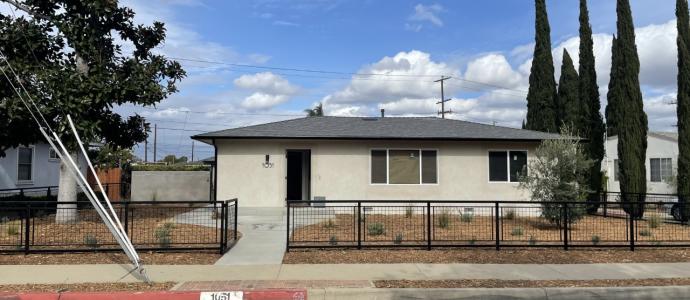 house with trees on either side and blue sky. how is located in California