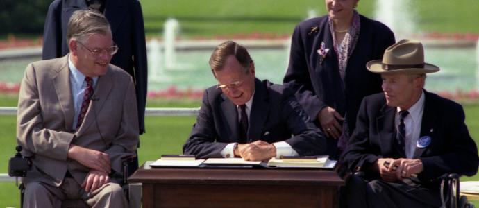 President George H.W. Bush signing the American with Disabilities Act on July 26, 1990