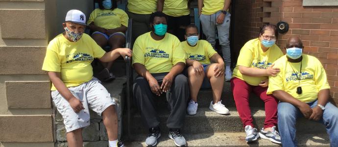 Group shot of people from YAI's East Tremont location, all wearing yellow Central Park Challenge Shirts