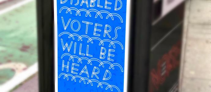 A sign that says "disabled voters will be heard" on the road in New York City