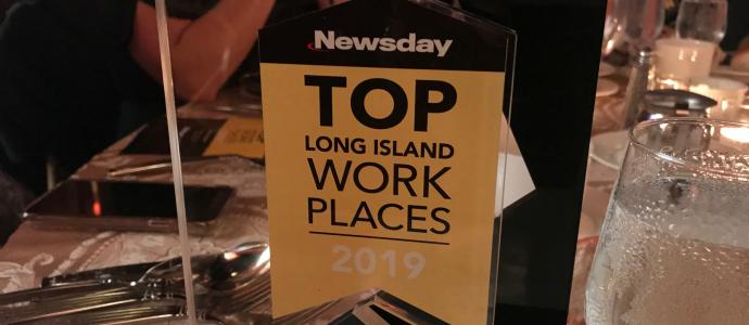 Award trophy with text "Newsday TOP Long Island Work Places 2019"