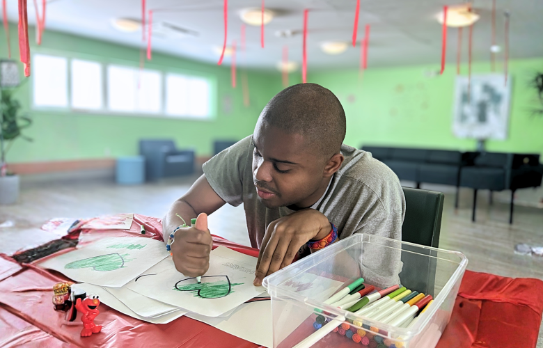 Justin at the respite center in Kingston, he's focused on coloring in. 