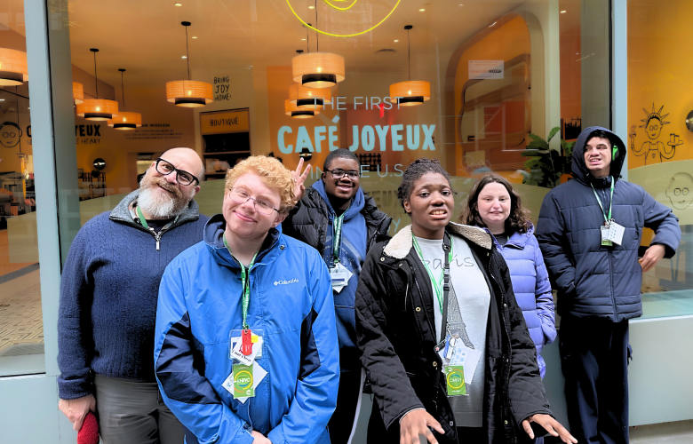 Group of 5 STAR students with staff stand outside a cafe for a group photo